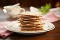 matzo bread stacked on a ceramic plate