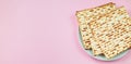 Matzo on a pink background. Traditional Jewish food.  for  regilious spring holiday of Pesach. Happy Passover. Copy space Royalty Free Stock Photo