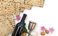 Matzo, wine, silver bowl, pink flowers apple tree, white egg and walnuts for passover celebration on white background Royalty Free Stock Photo