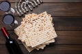 Matzos, red wine and menorah on wooden table, flat lay Royalty Free Stock Photo