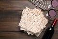 Matzos, red wine and menorah on wooden table, flat lay Royalty Free Stock Photo