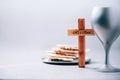 Matzos unleavened bread, chalice of wine, wooden cross on grey background. Christian communion for reminder of Jesus sacrifice. Royalty Free Stock Photo