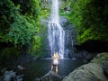 Maui, Hawaii Hana Highway, Sexy blonde girl admires Wailua Falls in Road to Hana