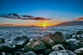 Maui Hawaii at sunset with a low sun and rocks and a mountain Royalty Free Stock Photo