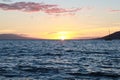 Maui Hawaii at sunset with a low sun and rocks and a mountain Royalty Free Stock Photo