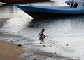 a child playing in the water on the beach