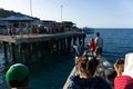 MAUMERE/INDONESIA-APRIL 26 2014: A boat is preparing to dock at the dock where many children are waiting for their arrival