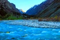 Mauntain valley, canyon. High snow-capped peaks, a river, stormy creek, stream, with blue mineral water.