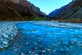 Mauntain valley, canyon. High snow-capped peaks, a river, stormy creek, stream, with blue mineral water.