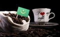 Mauritania flag in a bag with coffee beans isolated on black