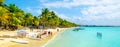 MAURITIUS - NOVEMBER 03, 2019: Sunny holiday in tropical paradise. Blue sea and sky, white sand beach and green palm Royalty Free Stock Photo