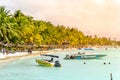 MAURITIUS - NOVEMBER 03, 2019: Sunny holiday in tropical paradise. Blue sea and sky, white sand beach and green palm Royalty Free Stock Photo