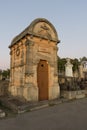 A mausoleum with carved cross, wreath and pillars in roussillon