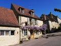 Mauve wisteria on a house facade in Domme, the most beautiful village in France in the Dordogne