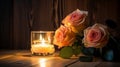 Beautiful roses and burning candles on a wooden background at night. Selective focus Royalty Free Stock Photo