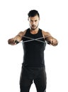 Maximum effort. Studio shot of a young man working out with a resistance band against a white background.