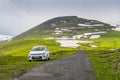 White kia rio car is parked by a narrow country road leading to Mount Aragats among picturesque Royalty Free Stock Photo