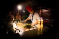 May, 2018 - Ari Atoll, Maldives: Happy teppanyaki chef cooking vegetables at teppan in a Japanese steakhouse on Mishi Sushi