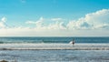 5 May 2019 : Balangan Beach, Bali, Indonesia - man carrying his surfboard on a sunny afternoon at the beach in Bali