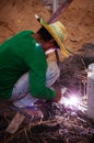 Asian male construction labour do metal welding work at construction site