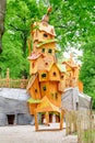Kids playing and having fun on the children`s playground in form of birdhouse