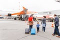 Late passenger on a runway at background of easy Jet airplane in Schonefeld airport