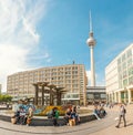 Panoramic view of Alexanderplatz square with famous TV tower and crowds of people