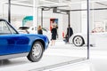 People tourists walking among Antique and modern cars in museum exhibition in Berlin