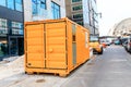 Yellow Cargo container using as accommodation for workers at construction site at the city street