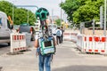 Young man from google corporation is working with huge backpack with 3D panoramic camera used for Royalty Free Stock Photo