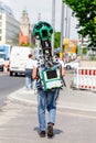 Young man from google corporation is working with huge backpack with 3D panoramic camera used for