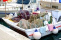 Multicolored fishing nets folded on the deck of a fishing boat. Royalty Free Stock Photo