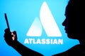 May 30, 2022, Brazil. In this photo illustration, the Atlassian Corporation logo is seen in the background of a silhouetted woman