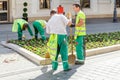 City communal service workers Planting flowers at flowerbed near city center, gardening and