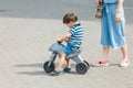 mother walking with her child son on a cute bicycle