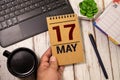May 17 calendar made wooden cubes gray background.