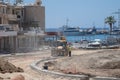 May 11, 2021 Cyprus, Paphos. Construction work with construction equipment and road renovation workers in city near