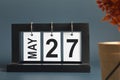 May 27, Date design with a black wooden calendar for a business.