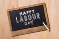 May Day, May 1. Small chalk board with text Labor Day. International Workers' Day