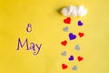 8 may day of month, colorful hearts rain from a white cotton cloud on a yellow background. Valentine's day, love and