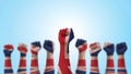 May day UK labour day concept with British United Kingdom flag pattern on people clenched fist of man`s hand isolated on blue sky