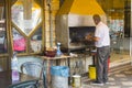 4 May 2018. A Druze Arab man cooking Halal meat on a restaurant barbeque with a stainless steel extractor chimney in the town of Royalty Free Stock Photo