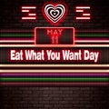 11 May, Eat What You Want Day, Neon Text Effect on bricks Background Royalty Free Stock Photo