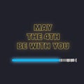 May the fourth be with you. Sci-fi yellow neon glowing letters and blue lightsaber Royalty Free Stock Photo