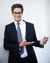 May I present the future of business technolgy. A handsome young businessman presenting a cellphone. Royalty Free Stock Photo