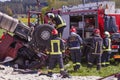 Fire rescue service working on accident place where truck rolled over to the roof