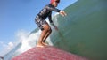 30 May 20188: Indonsia, Bali. Exciting action shot with camera on surf board of a young surfer Indonesian man paddling aggressive