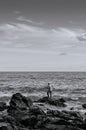 Local fisherman with fishing rod at Nui beach on Koh Lanta, Krabi, Thailand