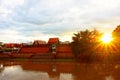 21 May 2023, Lamphun, Thailand, evening sunset Shining through the beautiful temple walls and river