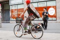 cool young tattooed punk man riding bicycle at city street